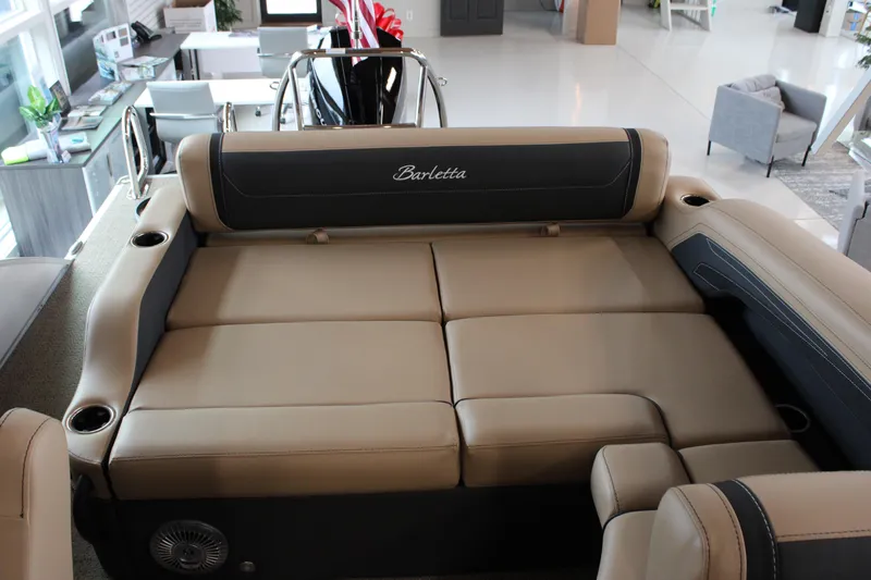 Slide: The Image of 2026 Barletta C24U boat interior with luxurious beige seating and cup holders. - 12