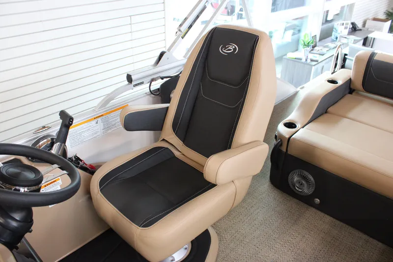 Slide: The Image of 2026 Barletta C24U boat interior with beige and black captain's chair and seating. - 13