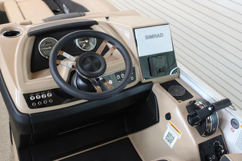Slide: The Image of 2026 Barletta C24U boat dashboard with steering wheel and Simrad display. - 14
