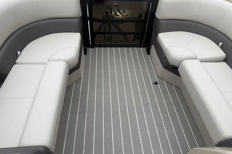 Slide: The Image of 2026 Bentley Pontoons Elite 223 Swingback interior with luxurious seating and striped flooring. - 14
