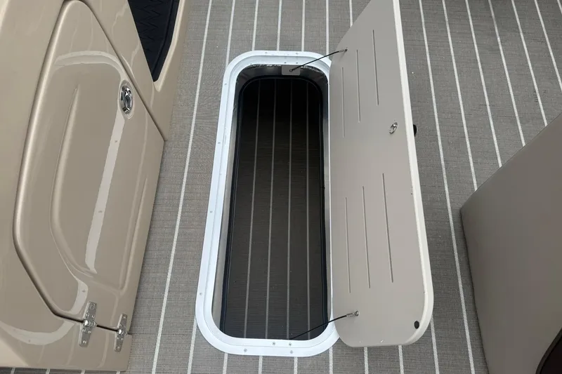 Slide: The Image of Open storage compartment on 2026 Bentley Pontoons Elite 223 Swingback boat deck. - 16