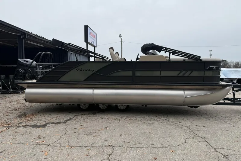 Slide: The Image of 2026 Bentley Pontoons Elite 223 Swingback pontoon boat parked on concrete surface. - 2