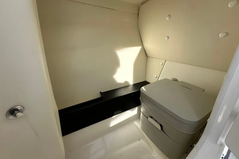 Slide: The Image of 2019 Yamaha Boats 242 Limited S E-Series interior with portable toilet. - 28