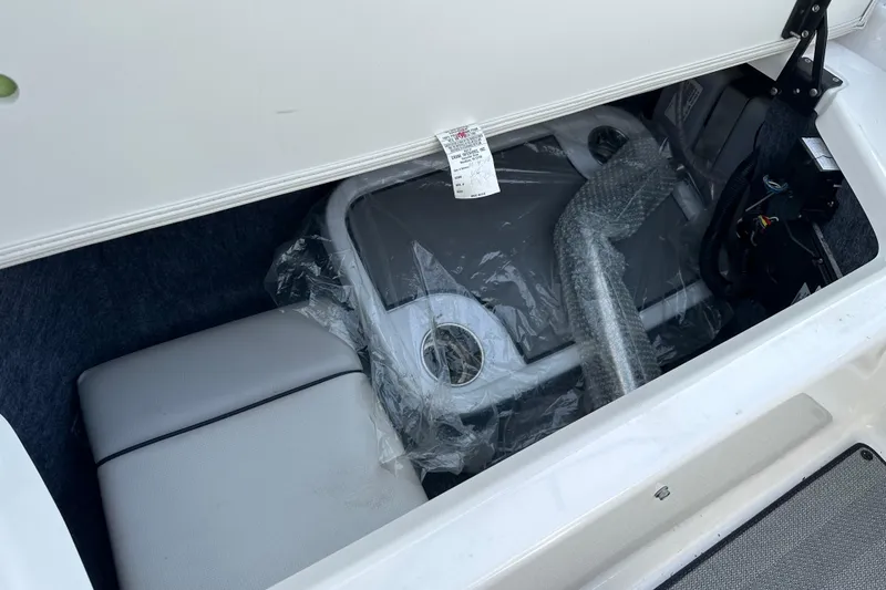 Slide: The Image of 2019 Yamaha Boats 242 Limited S E-Series storage compartment with wrapped accessories. - 29