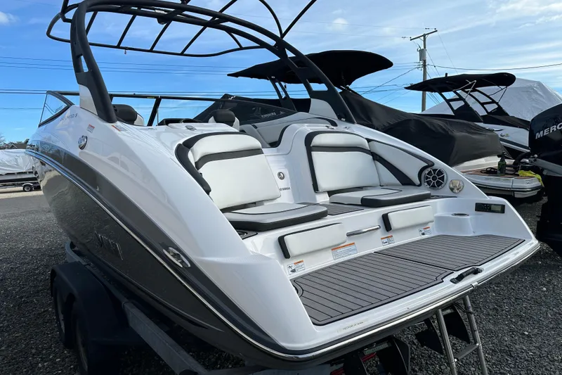 Slide: The Image of 2019 Yamaha Boats 242 Limited S E-Series, sleek design, white exterior, docked on trailer. - 33