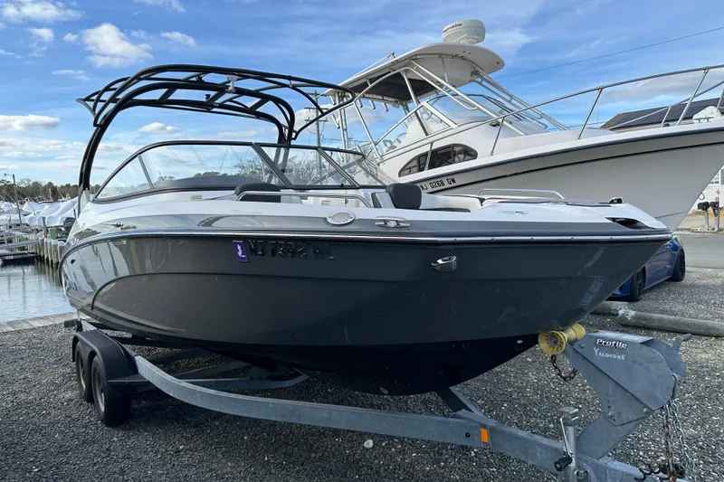 Slide: The Image of 2019 Yamaha Boats 242 Limited S E-Series on trailer at marina. - 35