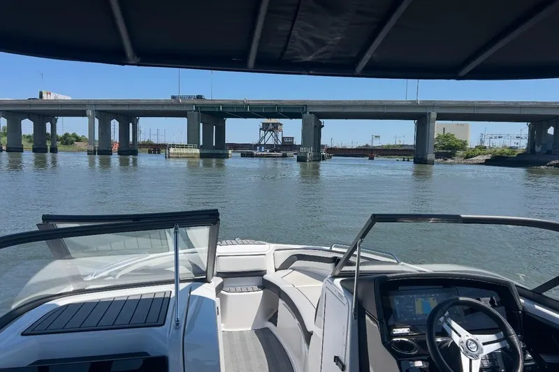 Slide: The Image of 2019 Yamaha Boats 242 Limited S E-Series interior with seating and storage compartments. - 5