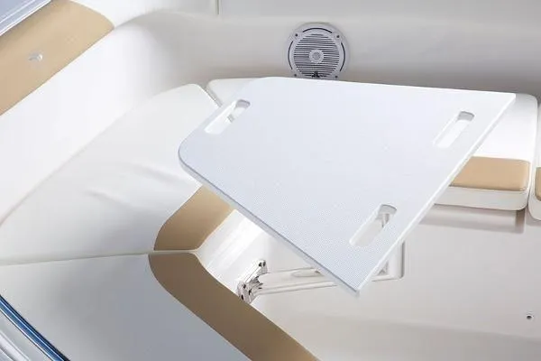 Slide: The Image of 2026 Edgewater 262CC boat interior with white table and cushioned seating. - 14