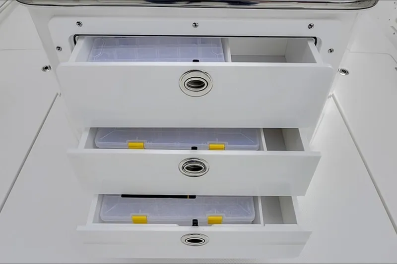 Slide: The Image of 2026 Edgewater 262CC boat storage drawers with organized compartments. - 4