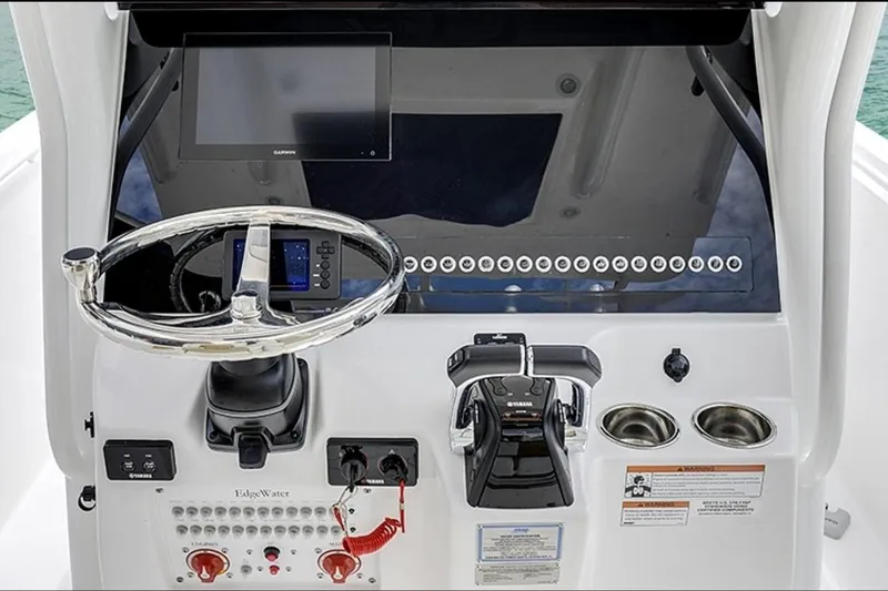 Slide: The Image of 2026 Edgewater 262CC boat console with steering wheel, controls, and display screen. - 5