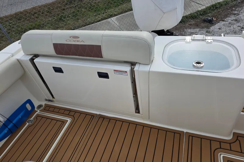 Slide: The Image of 2021 Cobia 237 Center Console boat interior with seating and livewell. - 10