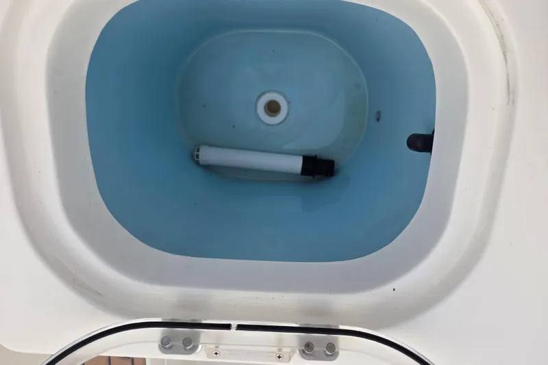 Slide: The Image of Livewell in 2021 Cobia 237 Center Console boat, featuring a blue interior. - 11