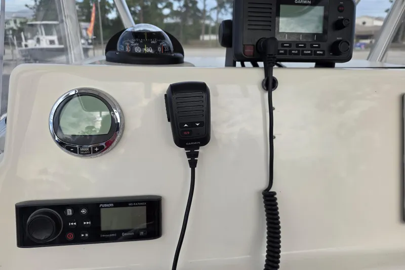 Slide: The Image of 2021 Cobia 237 Center Console dashboard with Garmin radio and compass. - 12