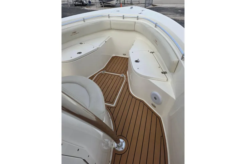 Slide: The Image of 2021 Cobia 237 Center Console boat interior with teak flooring and seating. - 13