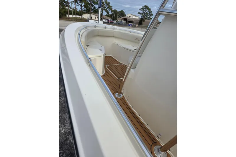 Slide: The Image of 2021 Cobia 237 Center Console boat with sleek deck and seating area. - 5