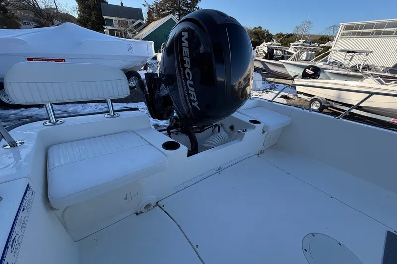 Slide: The Image of 2018 Boston Whaler 190 Montauk boat interior with white seating and steering console. - 10