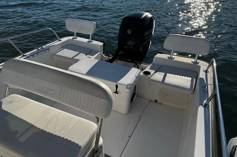 Slide: The Image of 2018 Boston Whaler 190 Montauk boat interior with seating and motor. - 12