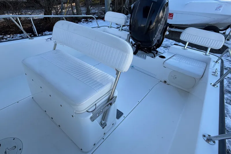 Slide: The Image of 2018 Boston Whaler 190 Montauk boat interior with steering wheel, on open water. - 14