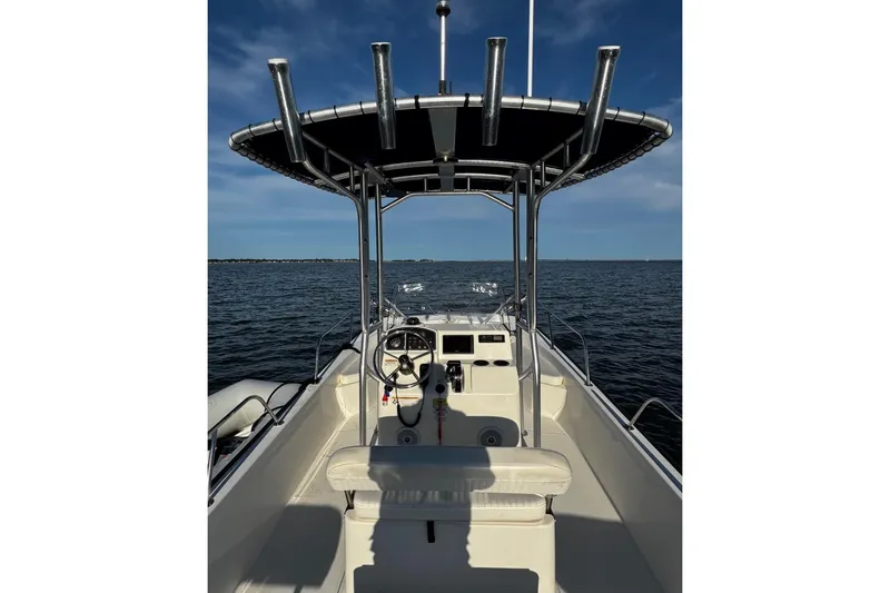 Slide: The Image of 2018 Boston Whaler 190 Montauk boat dashboard with steering wheel and controls. - 16