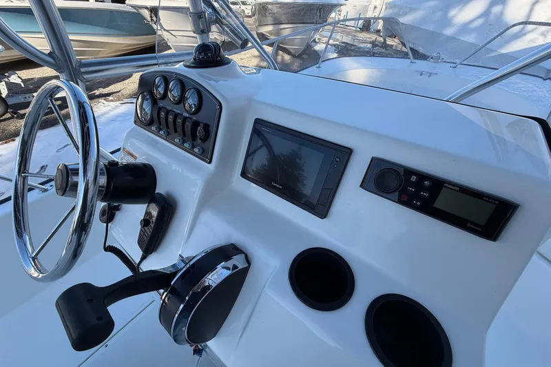 Slide: The Image of 2018 Boston Whaler 190 Montauk boat console with steering wheel and controls. - 18