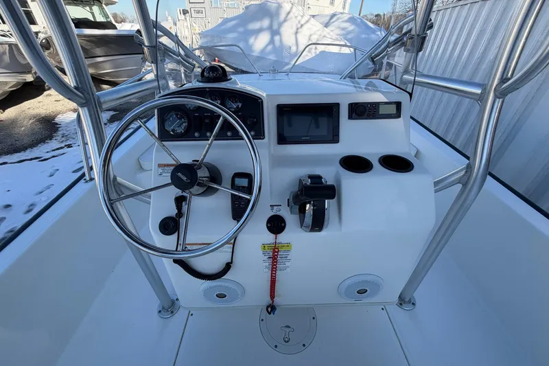 Slide: The Image of 2018 Boston Whaler 190 Montauk boat console with steering wheel and controls. - 19