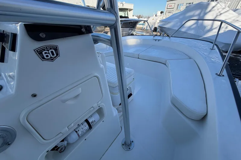 Slide: The Image of 2018 Boston Whaler 190 Montauk boat with T-top, parked in snowy marina. - 23