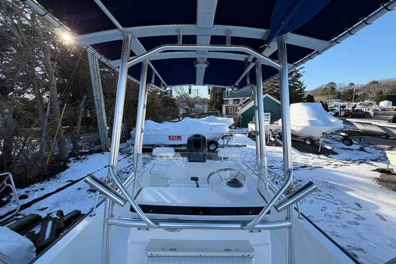 Slide: The Image of 2018 Boston Whaler 190 Montauk electrical compartment with wiring and battery setup. - 27