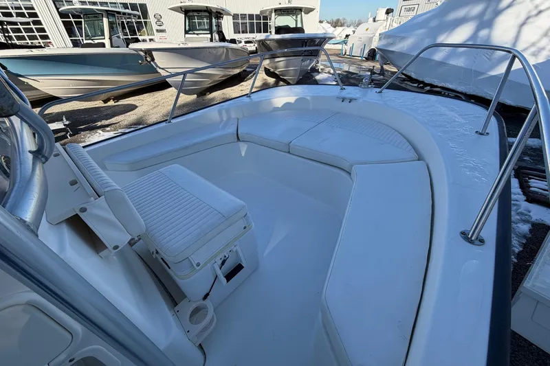 Slide: The Image of 2018 Boston Whaler 190 Montauk boat on water, featuring center console and T-top. - 32