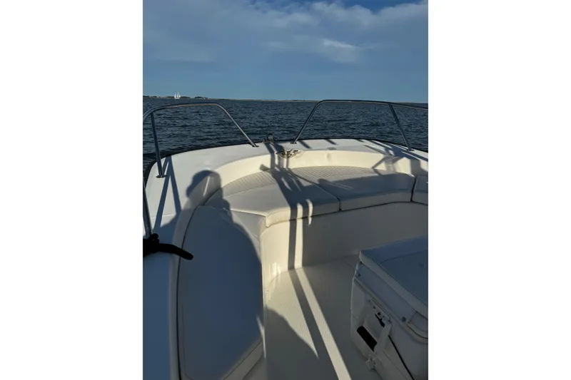 Slide: The Image of 2018 Boston Whaler 190 Montauk boat interior with cushioned seating and railings. - 33