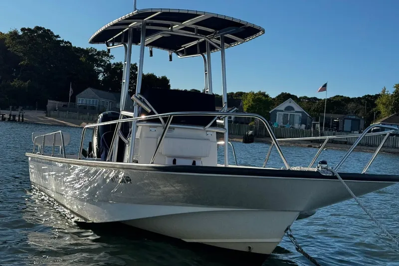 Slide: The Image of 2018 Boston Whaler 190 Montauk boat on calm water under blue sky. - 35
