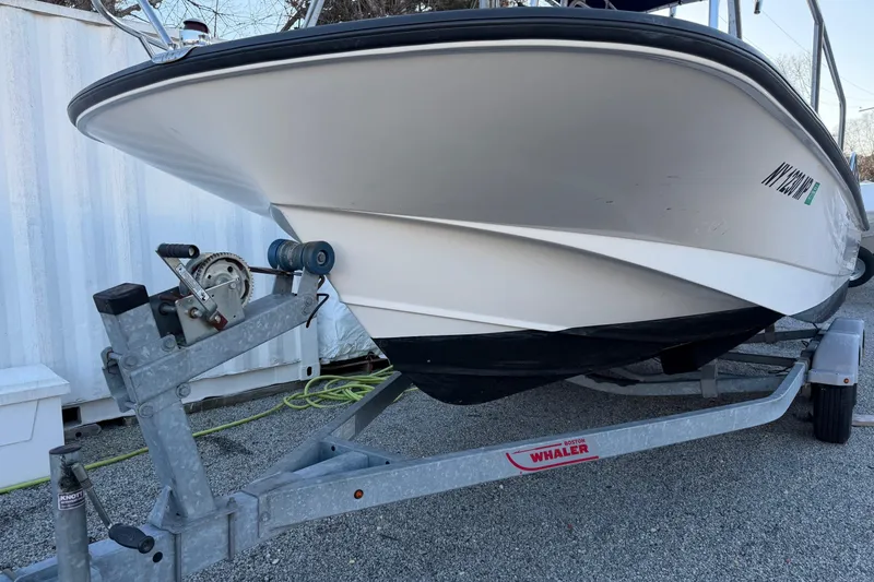 Slide: The Image of 2018 Boston Whaler 190 Montauk boat on trailer, parked outdoors. - 45
