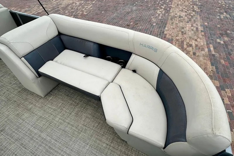Slide: The Image of 2023 Harris Cruiser 230 boat seating with plush upholstery and cup holders. - 16