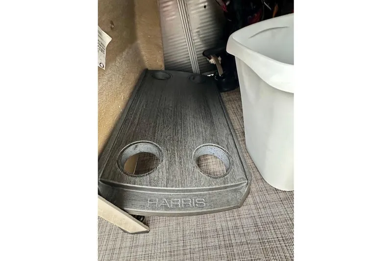 Slide: The Image of 2023 Harris Cruiser 230 interior with cup holders and storage area. - 21