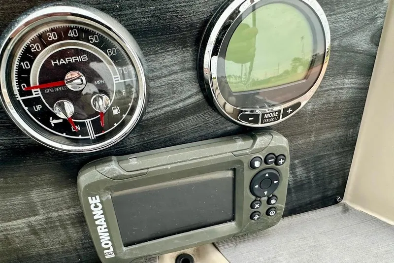 Slide: The Image of Dashboard of 2023 Harris Cruiser 230 with speedometer and Lowrance GPS device. - 26