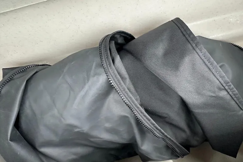 Slide: The Image of Black fabric with zippers on a 2023 Harris Cruiser 230 boat interior. - 30