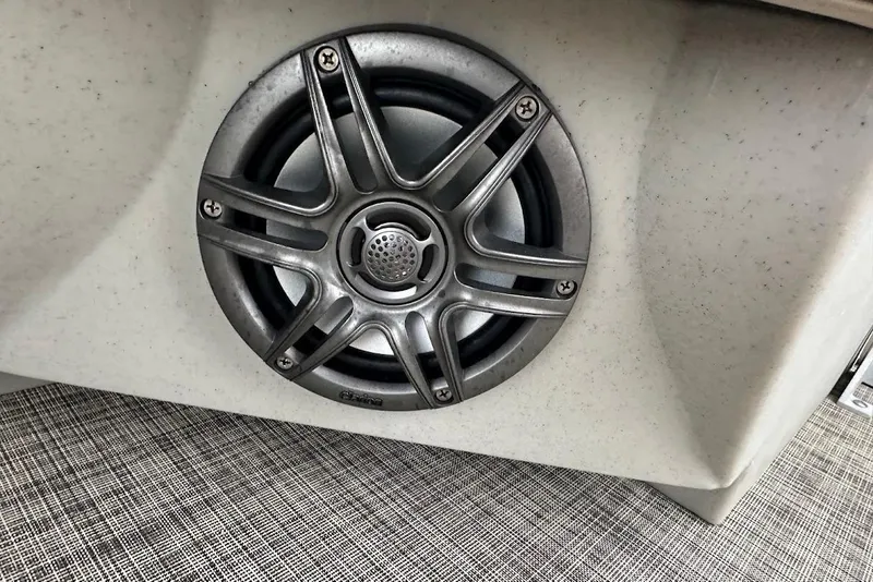 Slide: The Image of 2023 Harris Cruiser 230 speaker detail with metallic grille on textured surface. - 34