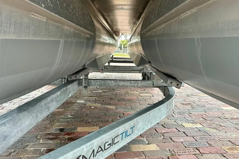 Slide: The Image of Underneath view of a 2023 Harris Cruiser 230 on a Magic Tilt trailer. - 5