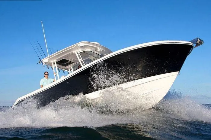 The Image of 2026 Edgewater 285CC boat navigating ocean waves under clear blue sky. - 1