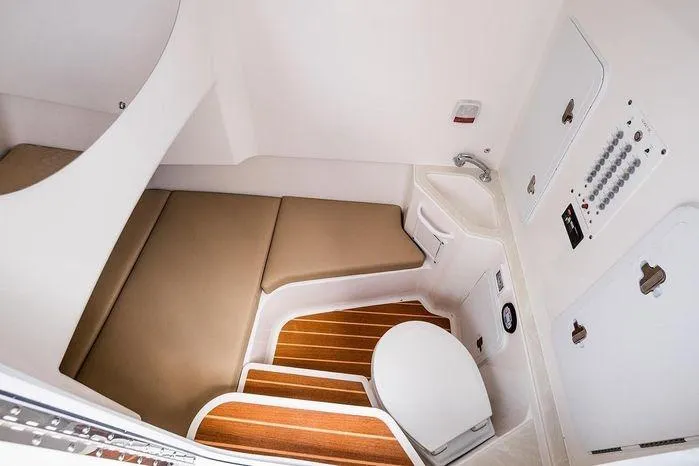 Slide: The Image of Interior cabin of 2026 Edgewater 285CC boat with seating, sink, and control panel. - 11
