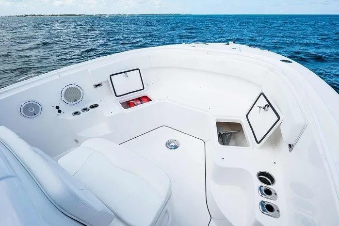 Slide: The Image of 2026 Edgewater 285CC boat interior with open storage, ocean view, and seating. - 13