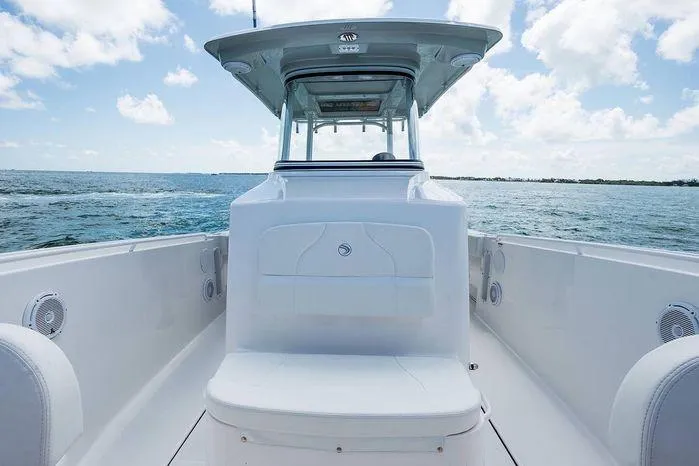 Slide: The Image of 2026 Edgewater 285CC boat on open water under a clear sky. - 15