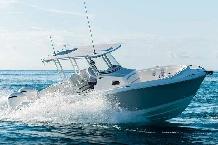 Slide: The Image of 2026 Edgewater 285CC boat cruising on open water, showcasing sleek design and powerful engines. - 3