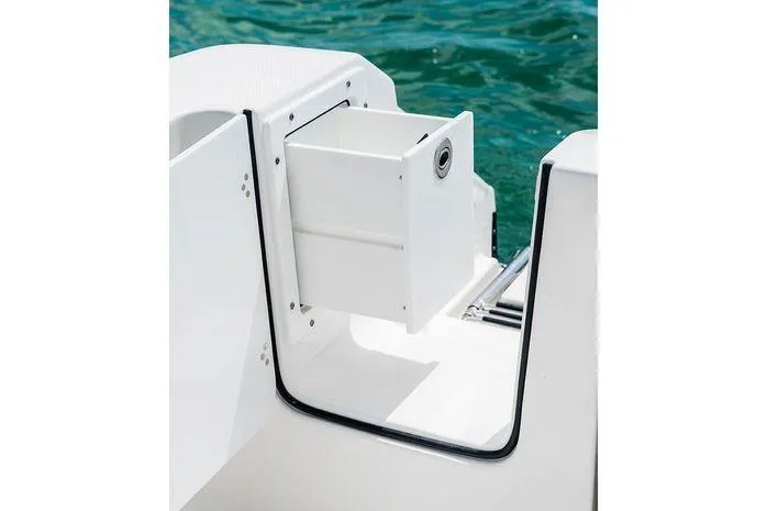 Slide: The Image of 2026 Edgewater 285CC boat detail with white storage compartment by the water. - 4