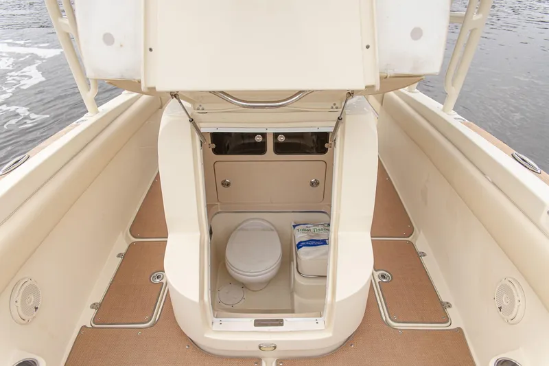 Slide: The Image of 2016 Chris-Craft Catalina 26 boat interior with a compact marine toilet. - 12