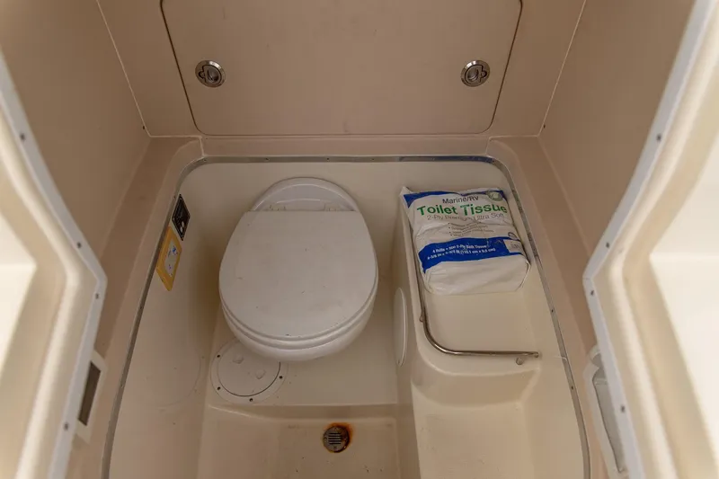 Slide: The Image of 2016 Chris-Craft Catalina 26 boat bathroom with toilet and marine toilet tissue. - 13