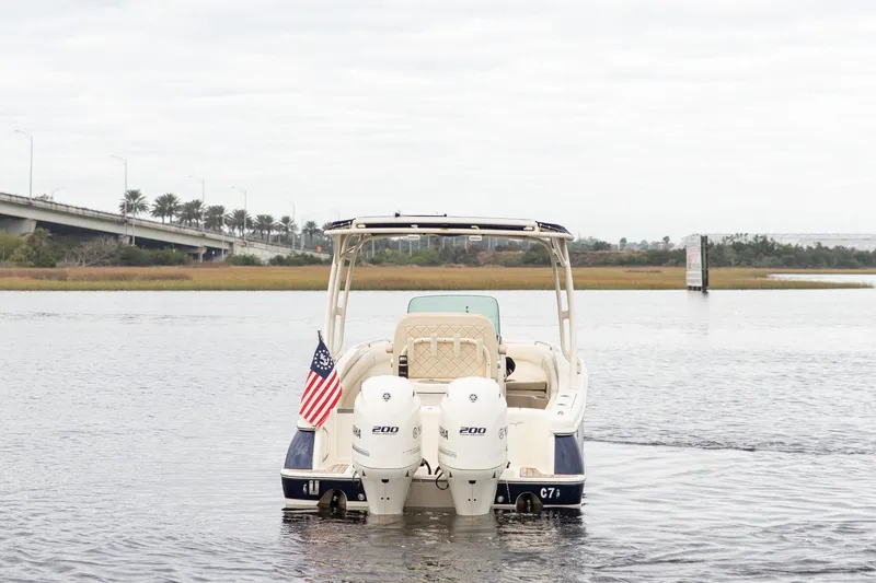 Slide: The Image of 2016 Chris-Craft Catalina 26 boat with dual engines on a calm waterway. - 3