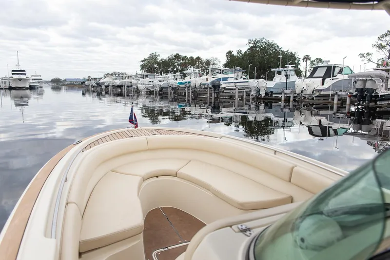 Slide: The Image of 2016 Chris-Craft Catalina 26 boat docked in a marina with calm waters and overcast sky. - 8