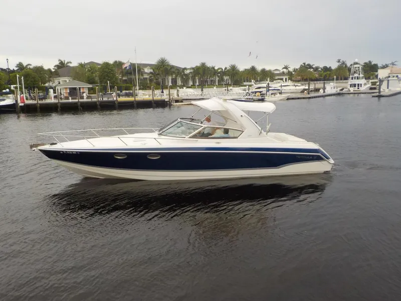 Slide: The Image of 2006 Formula 330 SS boat cruising on a calm marina. - 1