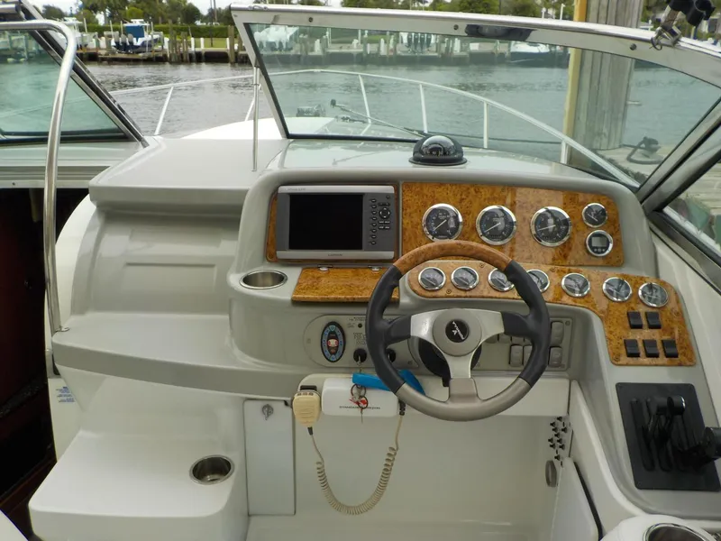 Slide: The Image of 2006 Formula 330 SS boat dashboard with steering wheel and navigation instruments. - 5