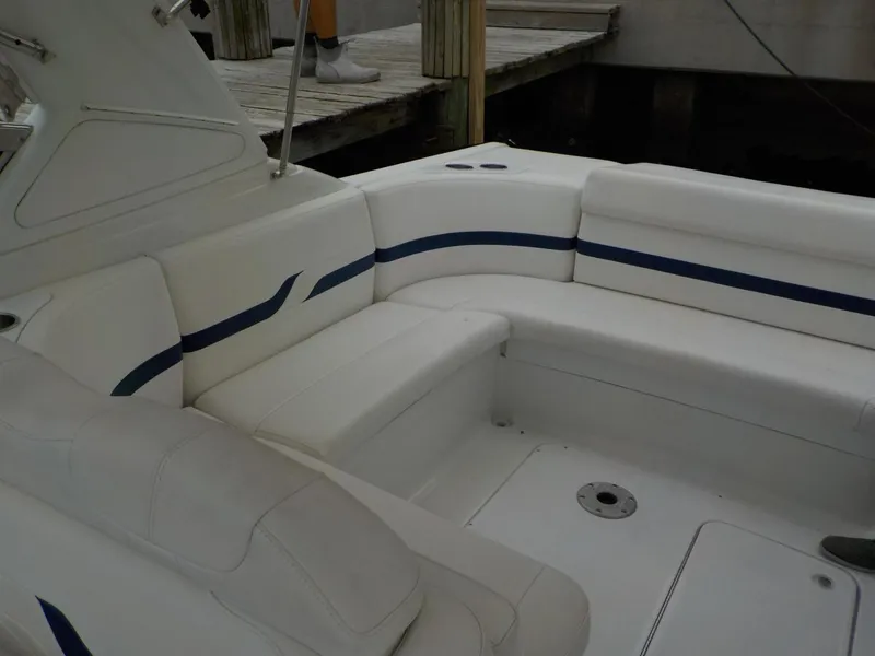 Slide: The Image of 2006 Formula 330 SS boat interior with white seating and blue accents. - 9